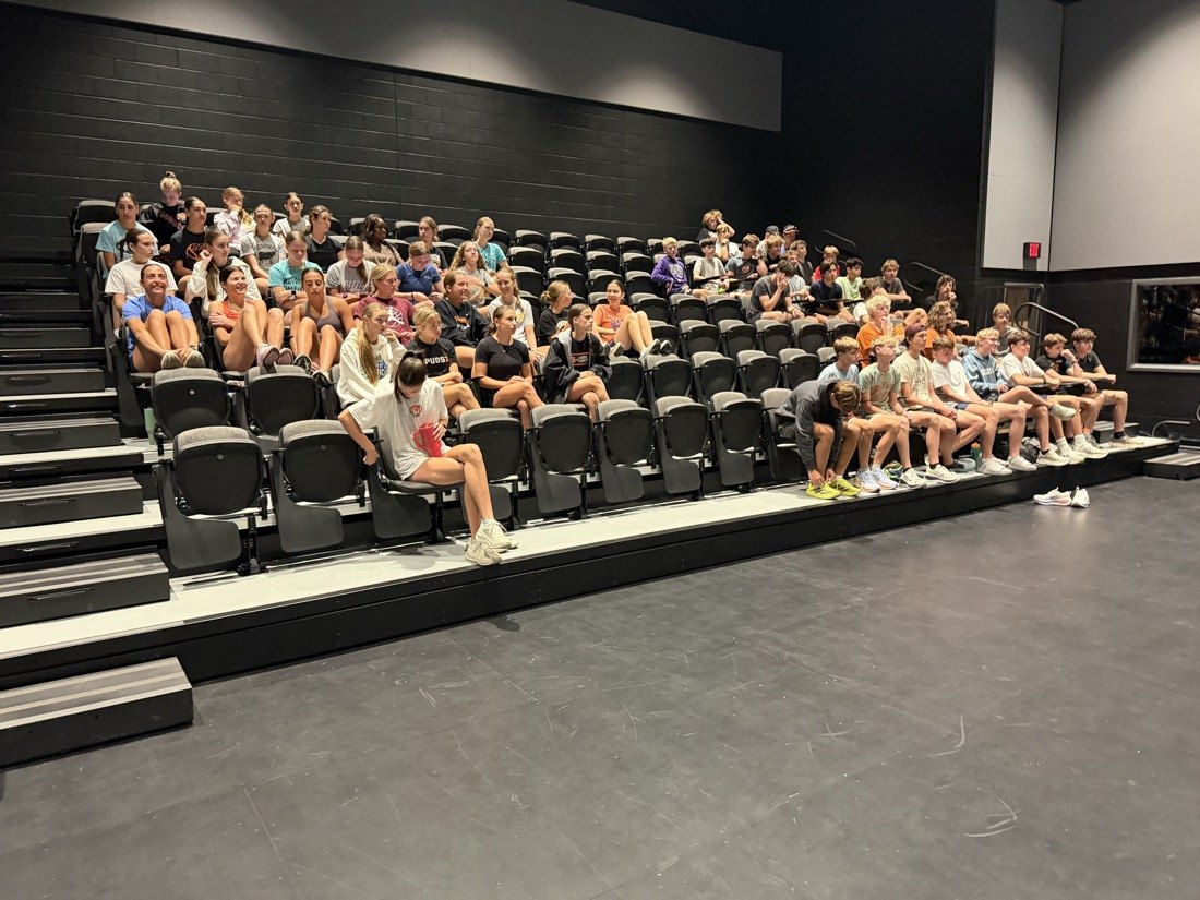 The Moorhead Spuds cross country team at a meeting in a new space at Moorhead High School