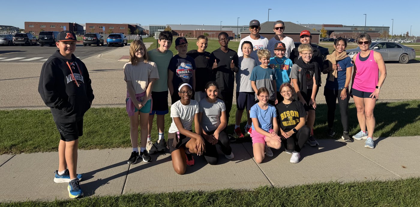 Horizon runners and Coach Kit with the Miles for Kids runner outside school