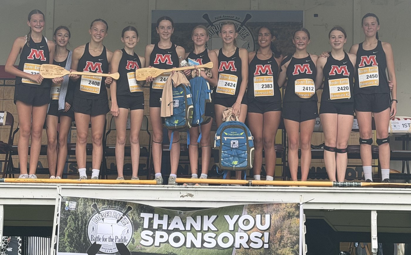 The Moorhead eighth grade girls on the podium holding the Border Battle paddle
