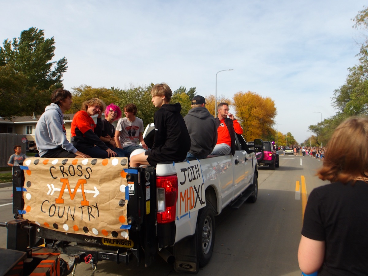 The back of the Spuds cross country float, with a hand painted Cross Country banner and a Join MHD XC sign